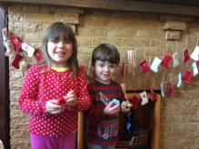 Eleanor and Sebastian opening up their advent calendar gifts